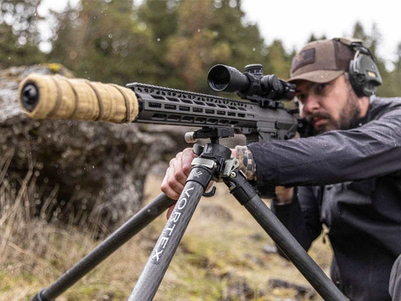 Man shooting gun with suppressor